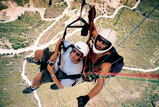 Turkish Republic of Northern Cyprus, Cyprus - September 24, 2015: A senior adventure tourist tandem paragliding in Northern Cyprus (Turkish Republic of Northern Cyprus). 