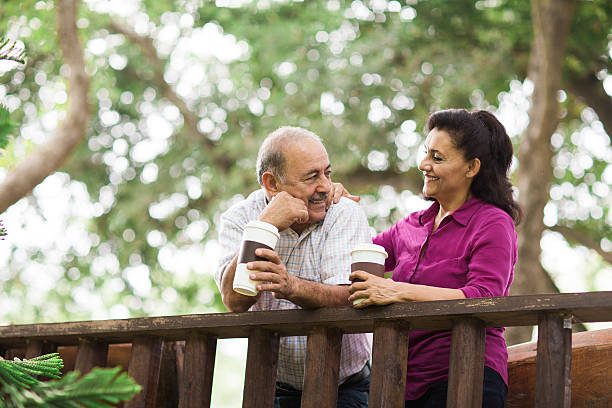 istock Senior latin couple drinking coffee outside 576745278