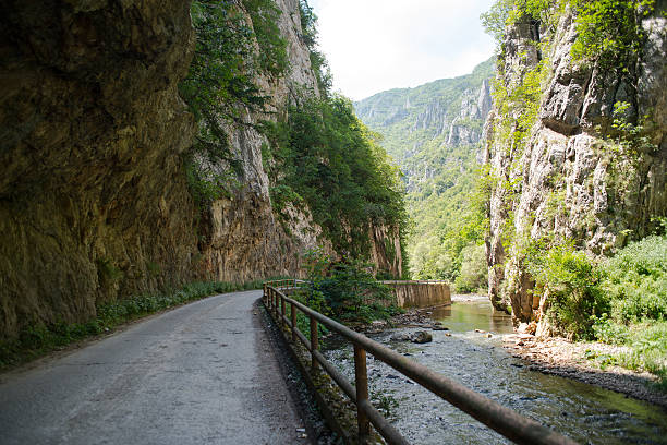 Mountain road leads  through canyon
