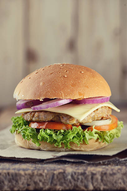 istock Hamburger closeup on wood background 576747884