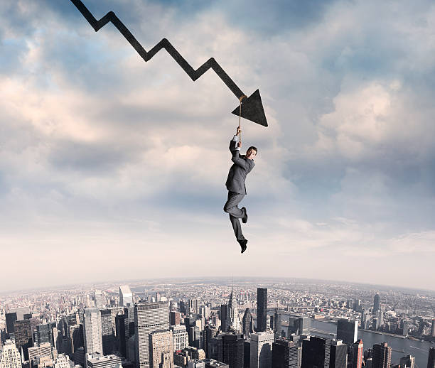 istock Businessman Clings To Rope Dangling From Arrow 576748502