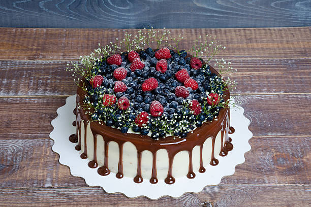 istock color drip cake with blueberries and raspberries 576750240
