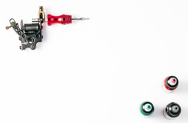 istock Tattoo machine and three bottles of ink 576752350