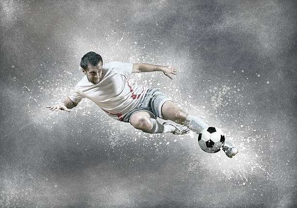 istock Football player with ball in action under sky with clouds 576752910