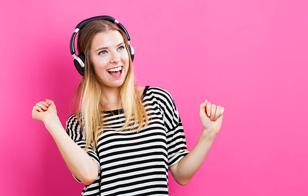 istock Happy young woman with headphone 576755356