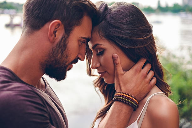 istock Couple touching with heads before kissing 576756928