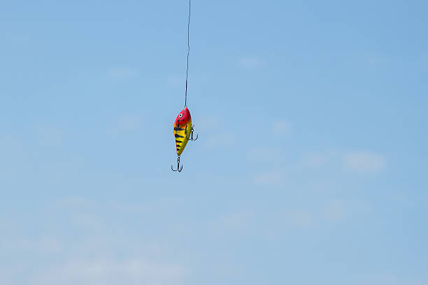 istock Bright lure predator spinning against the blue sky 576892268