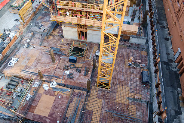 istock Crane rising through floor of highrise under construction 576892308