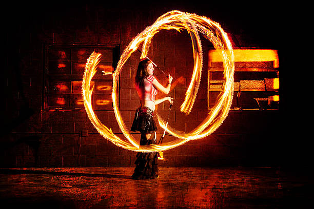 istock Beautiful Woman Spinning Fire and Dancing 576893318