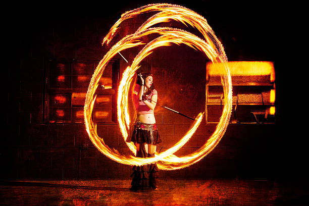 istock Beautiful Woman Spinning Fire and Dancing 576893352