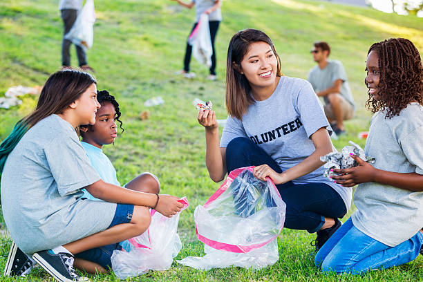 istock Mother and her daughters help clean up community 576893652