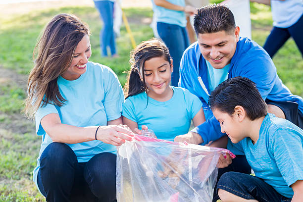 istock Happy family picks up garbage in their community 576893730