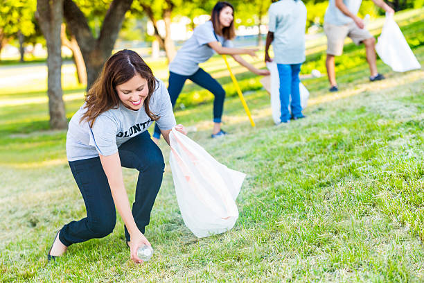 istock Female volunteer helps with park beautification 576893800