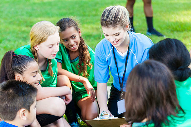istock Pretty soccer coach huddling up with her players 576893980