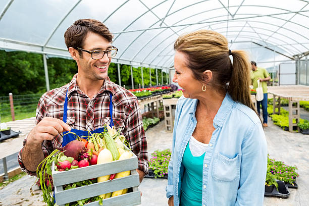 istock Caucasian farmer assists senior customer 576894344