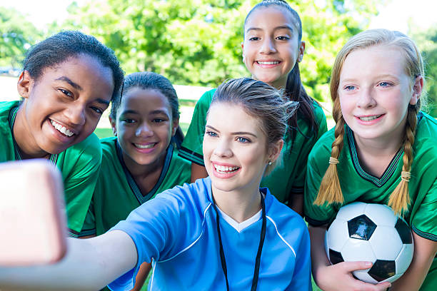 istock Happy soccer team take selfie with coach 576894654
