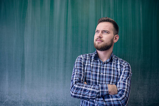 istock Handsome Young Student in Front of School Blackboard 576895644