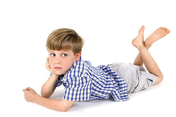 Photo of teenage handsome guy posing at studio. Fashion portrait of cute pretty teen boy