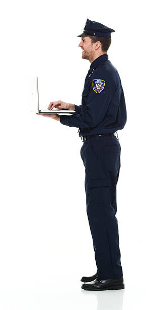 istock Smiling police working on laptop 576897878