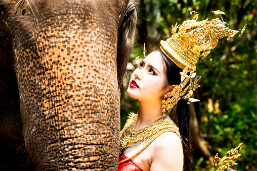 Tradtionally dressed Thai model with an elephant.
