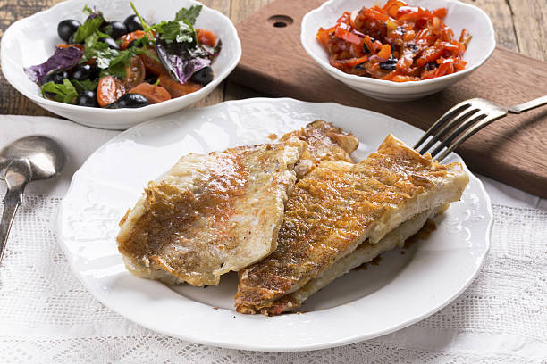 fried rose fish fillet on a white plate. - rockfish imagens e fotografias de stock