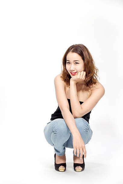istock sexy thai lady sitting on her knee 576902336