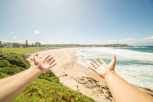 istock Person's arms stretch towards Bondi beach, Australia 576902706