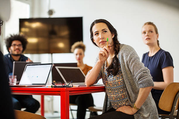 woman with coworkers in conference room - laptop partnership looking communication imagens e fotografias de stock