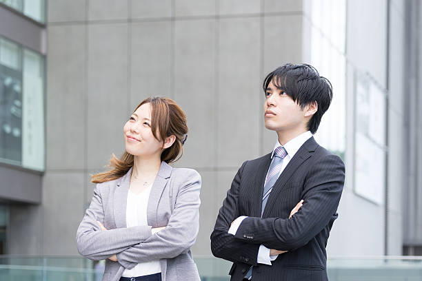 istock Men and women look up at top with arms folded 576903164
