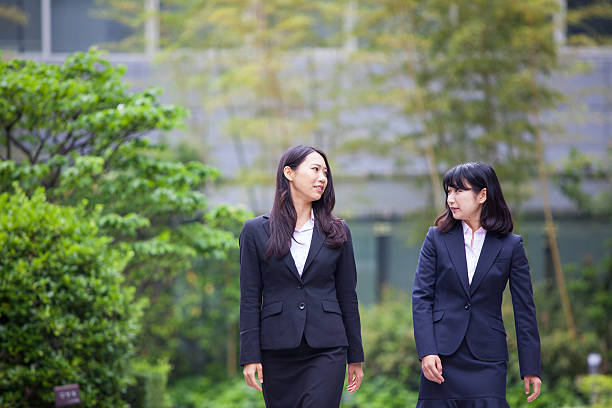 istock Two corporate women talking and walking 576904510