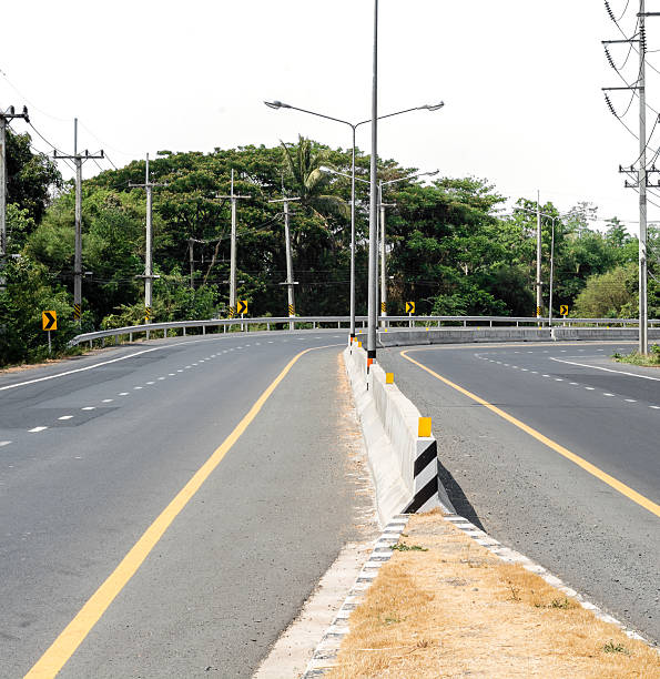 istock Curve road in white sky with copy space 576905268