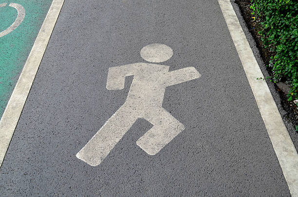 istock Running sign in running track on asphalt road 576906976