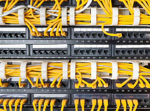 istock Close up of yellow network cables connected to switch 576908100