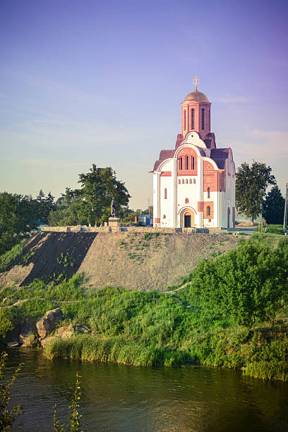 istock Christian church on a hill by the river 576909028