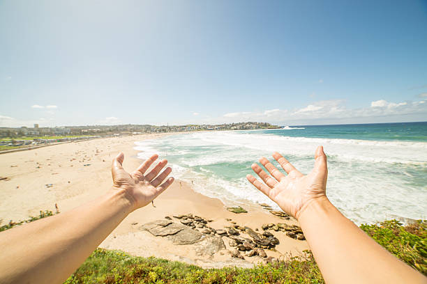 istock Woman's arms stretch towards Bondi beach, Australia 576909698