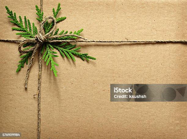 Cardboard Tied With Green Twigs And Rope Stock Photo - Download Image Now - Christmas, Wrapping Paper, Backgrounds