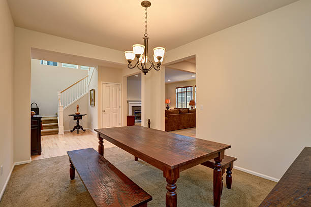 istock Open floor plan. View of dining room with wooden table 576910058