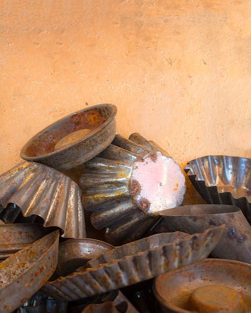 Vintage Rusty baking tins in various sizes against orange metal background