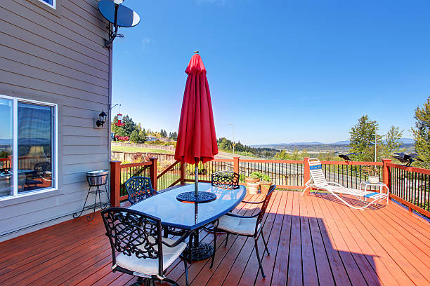 istock Wooden walkout deck with patio table overlooking beautiful landscape 576911844