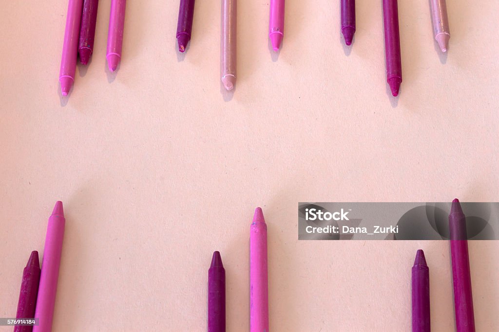Pink And Purple Crayons On Colorful Background Stock Photo