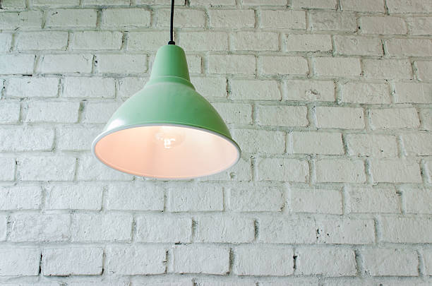 istock brick concrete room with ceiling lamps 576915620