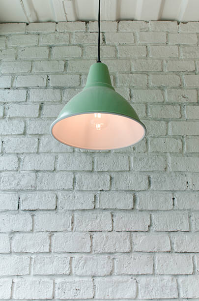 istock brick concrete room with ceiling lamps 576916046