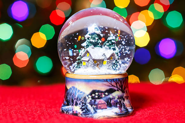 istock Christmas Snow Globe in front of Christmas tree lights 576918708