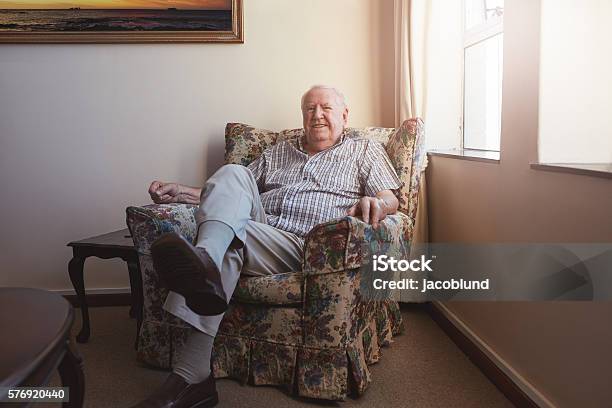 Relaxed Elderly Man Sitting On A Arm Chair Stock Photo - Download Image Now - Senior Men, Domestic Life, Sofa