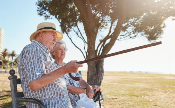 istock Senior couple relaxing on a park bench 576921042