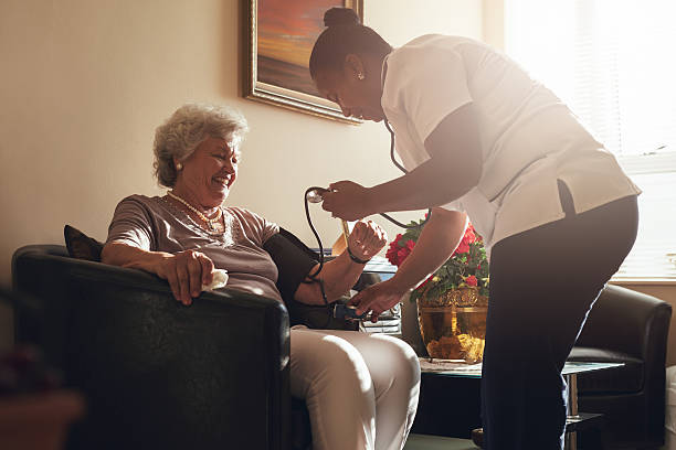 은퇴 가정에서 노인 환자의 혈압을 측정하는 간호사 - nursing home nurse blood pressure gauge home caregiver 뉴스 사진 이미지