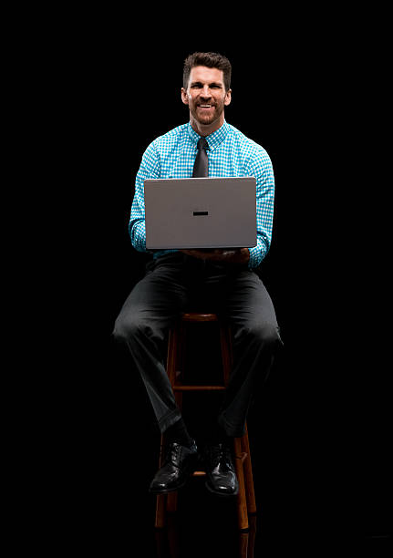 istock Smiling businessman working on laptop 576921690