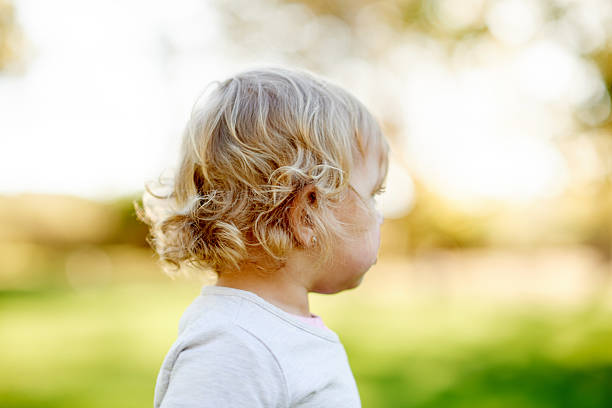 Outdoor portrait of a young girl with long hair on natural background