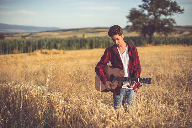 istock Playing guitar in the nature 576924026