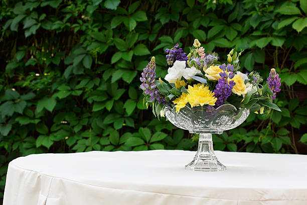 istock Beautiful flower bouquet outdoors. Wedding floristic decoration at white table 576926954